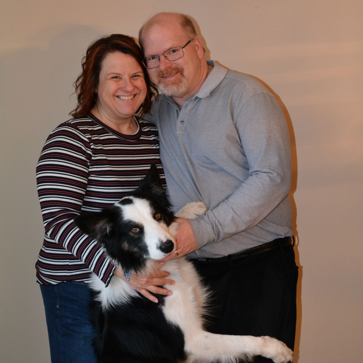 A photo of Donna Lake, her dog and her husband.